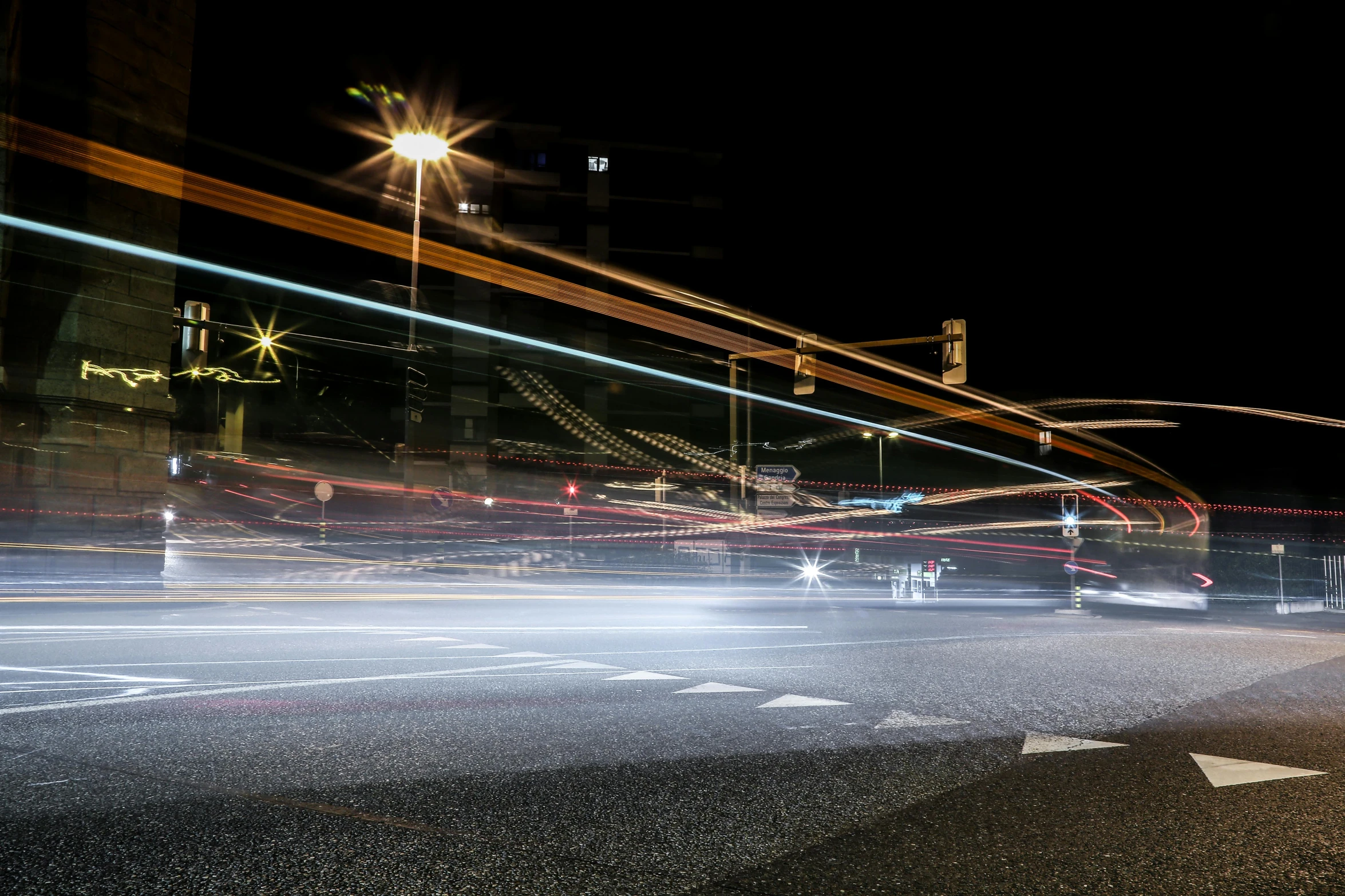 a city street filled with lots of traffic at night, a picture, by Thomas Häfner, unsplash, energy trails, streetlight, photographed for reuters, taken on a 2010s camera