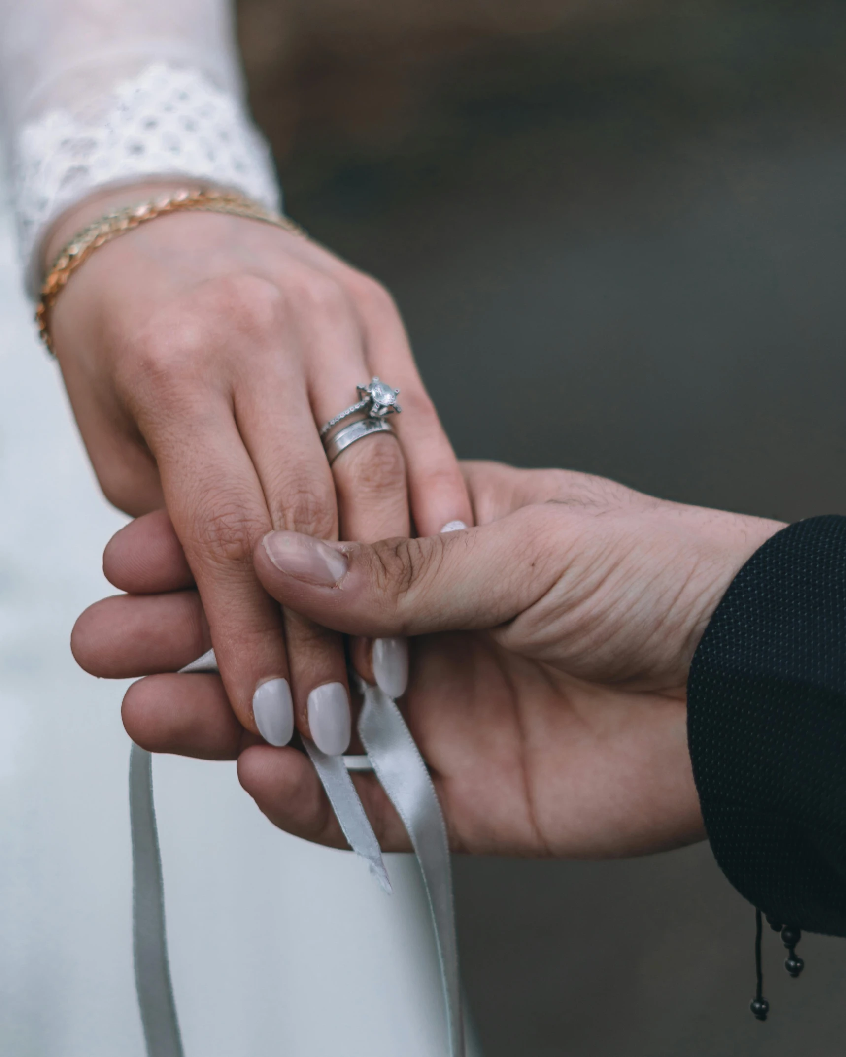 a close up of a person holding a wedding ring, unsplash, ribbons, jordan grimmer and natasha tan, multiple stories, thumbnail