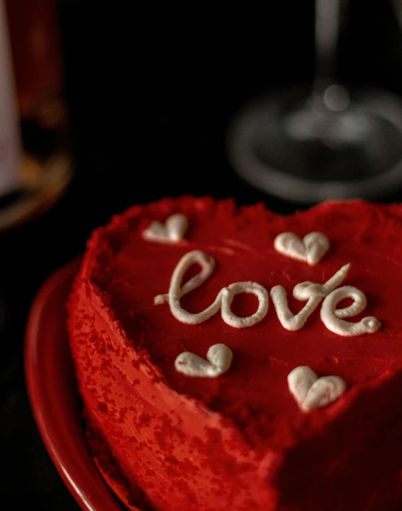 a red heart shaped cake sitting on top of a red plate, pexels, thumbnail, lgbt, wine, red writing