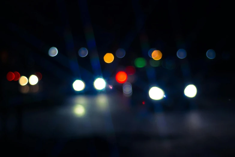 a blurry image of a city street at night, unsplash, police car lights, overcast bokeh - c 5, multicolored, concert lights