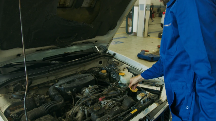 a man working on a car in a garage, subaru, holding a battery, 15081959 21121991 01012000 4k, ultra detail