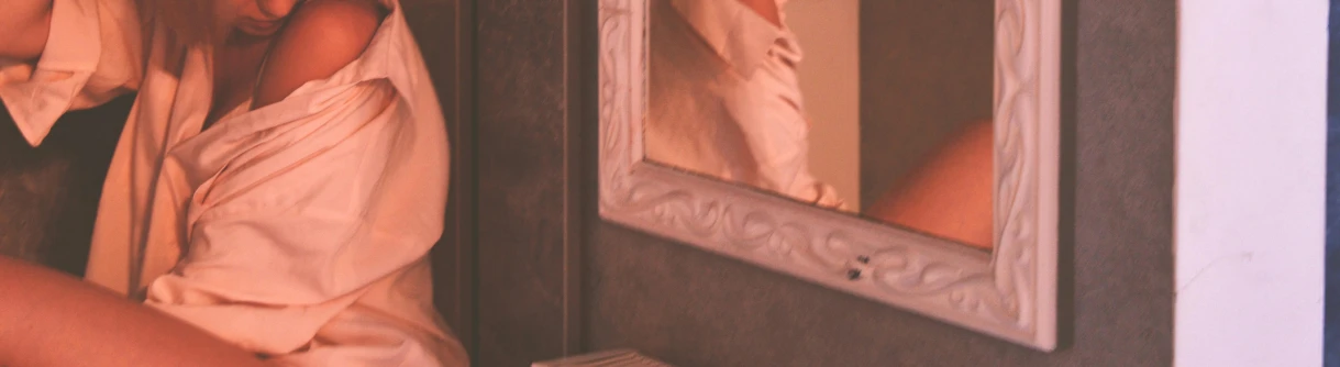 a woman taking a picture of herself in a mirror, a photorealistic painting, inspired by Allan Ramsay, trending on unsplash, tonalism, redscale photography, detail shot, detailed photo of an album cover, looking around a corner