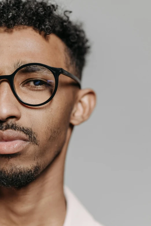 a close up of a person wearing glasses, inspired by Barthélemy Menn, black main color, ashteroth, detailed product image, handsome and attractive