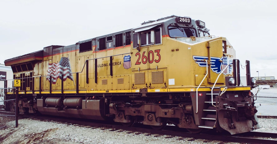 a yellow train sitting on top of a train track, profile image, up close, 🚿🗝📝