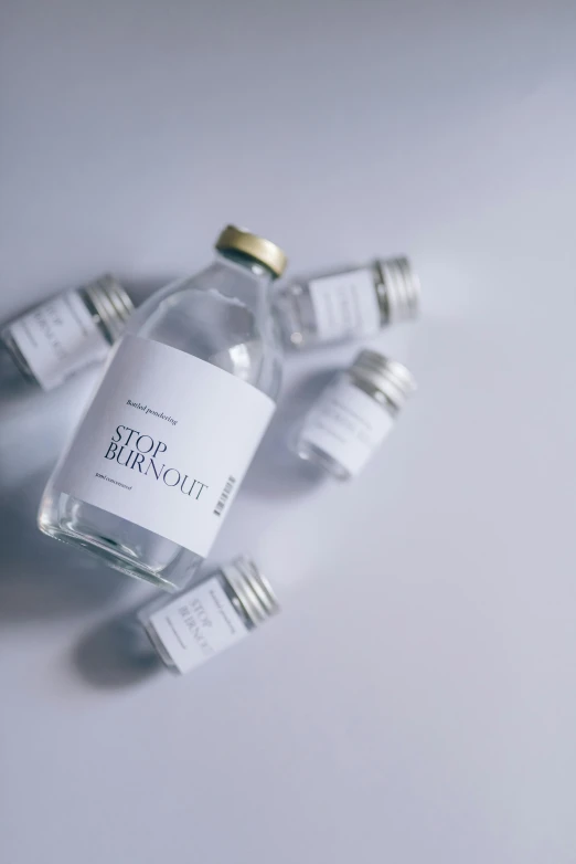 a group of empty bottles sitting on top of a table, by Nina Hamnett, unsplash contest winner, product label, white, diecut, soft blur