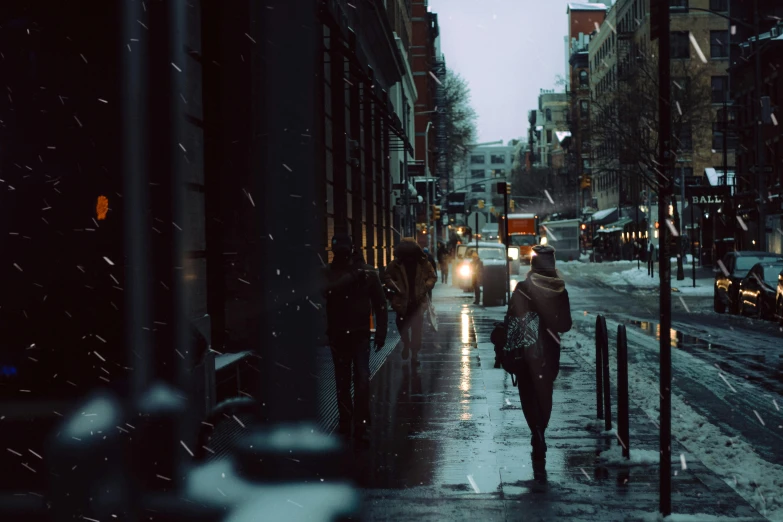 a person walking down a street in the snow, inspired by Elsa Bleda, pexels contest winner, realism, at evening during rain, scandinavian, thumbnail, multiple stories