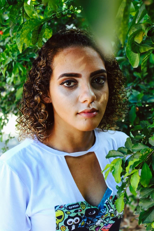 a woman standing in front of a tree, an album cover, inspired by Esaias Boursse, unsplash, thick bushy straight eyebrows, curls, 🤤 girl portrait, greek ameera al taweel