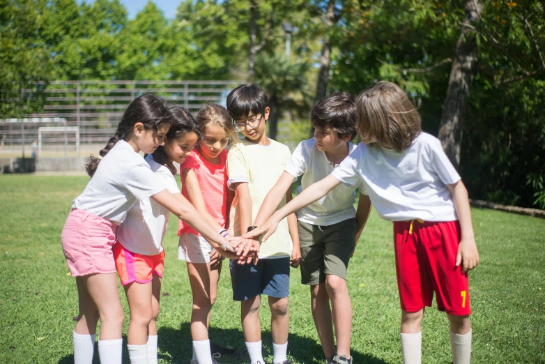 a group of children holding hands in a circle, a portrait, by Nina Hamnett, shutterstock, sport game, summer camp, profile image