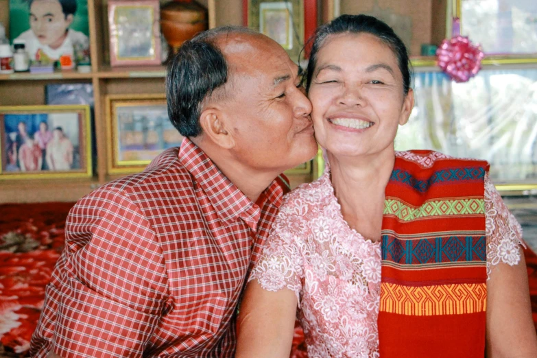 a man giving a woman a kiss on the cheek, a portrait, pexels contest winner, dau-al-set, cambodia, a still of a happy, profile image, at home