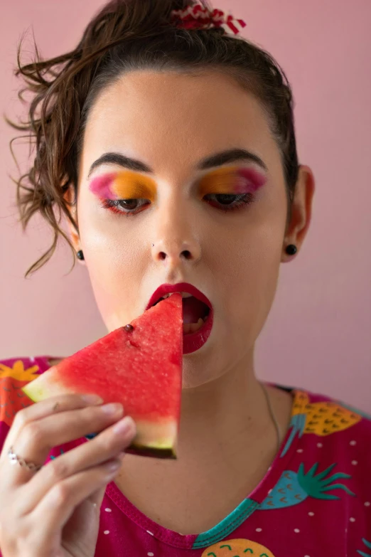 a woman is eating a slice of watermelon, inspired by Elsa Bleda, trending on pexels, pop art, bright eye makeup, lesbians, isabela moner, a colorful