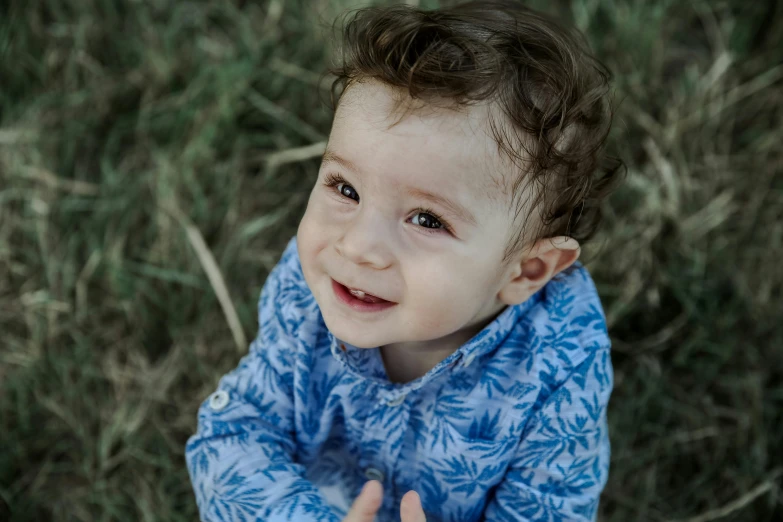 a close up of a child holding a frisbee, by Will Ellis, pexels contest winner, smiling male, patterned, toddler, lachlan bailey