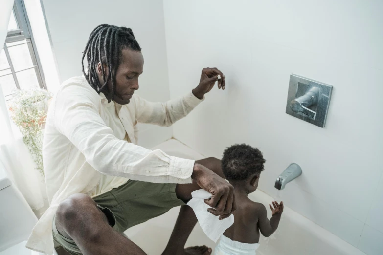 a man brushing a child's teeth in a bathroom, by Daniel Gelon, pexels contest winner, conceptual art, : kendrick lamar, ignant, courtesy of moma, playing with the water