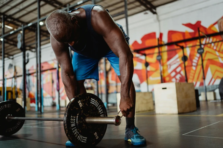 a man lifting a barbell in a gym, pexels contest winner, emmanuel shiru, sweaty insane, avatar image, lachlan bailey