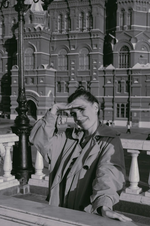 a black and white photo of a man on a cell phone, inspired by Andrei Ryabushkin, temples behind her, in 1 9 9 5, posing for a picture, museum background