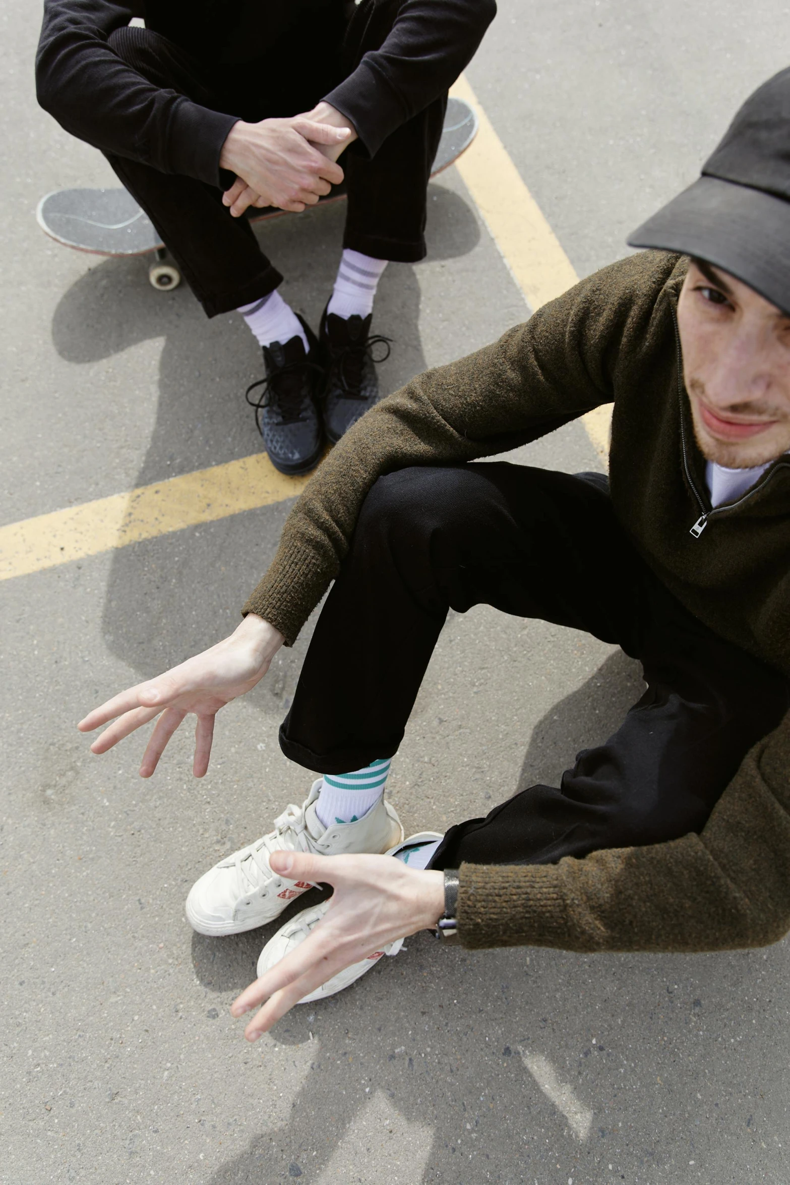 a group of young men sitting on top of a parking lot, an album cover, inspired by Seb McKinnon, sock cap, plays skateboards, high quality photo, nathan for you