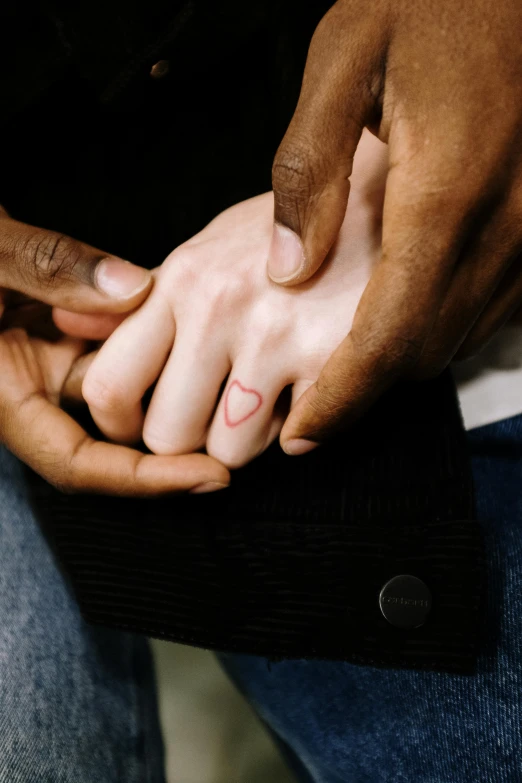 a close up of a person holding a person's hand, a tattoo, black man, jen atkin, hearts, ignant