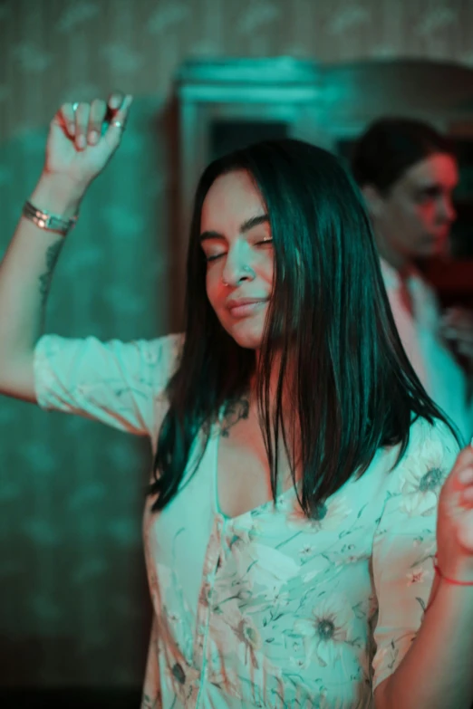 a woman in a white dress dancing at a party, an album cover, inspired by Elsa Bleda, trending on pexels, brunette woman, ( ( theatrical ) ), religious, gif
