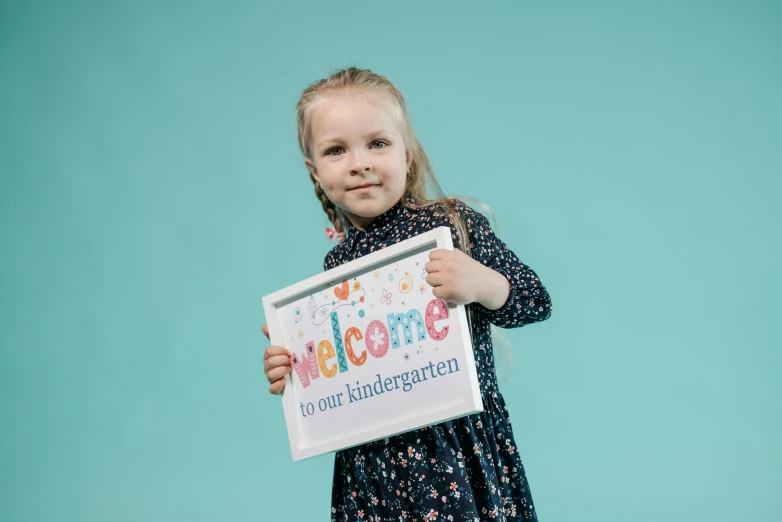a little girl holding up a welcome sign, a picture, by Arabella Rankin, shutterstock, official product photo, photography of kurzgesagt, carrying a tray, dot pupils