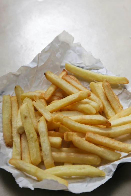 a basket of french fries sitting on top of a table, parchment paper, # nofilter, various sizes, australia