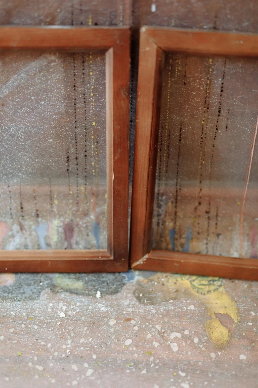 a couple of wooden frames sitting on top of a floor, a silk screen, gold raining in the background, nesting glass doors, restoration, close up