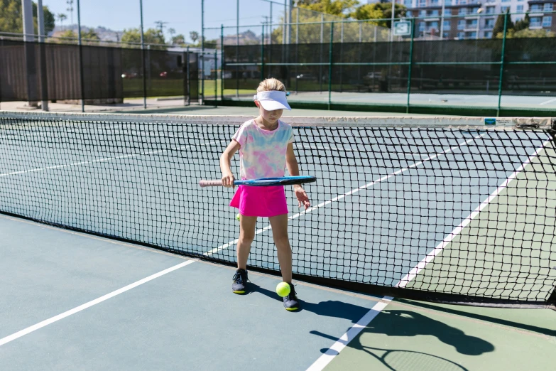 a woman standing on top of a tennis court holding a racquet, a girl playing tennis, with neon visor, 4yr old, soft surfaces
