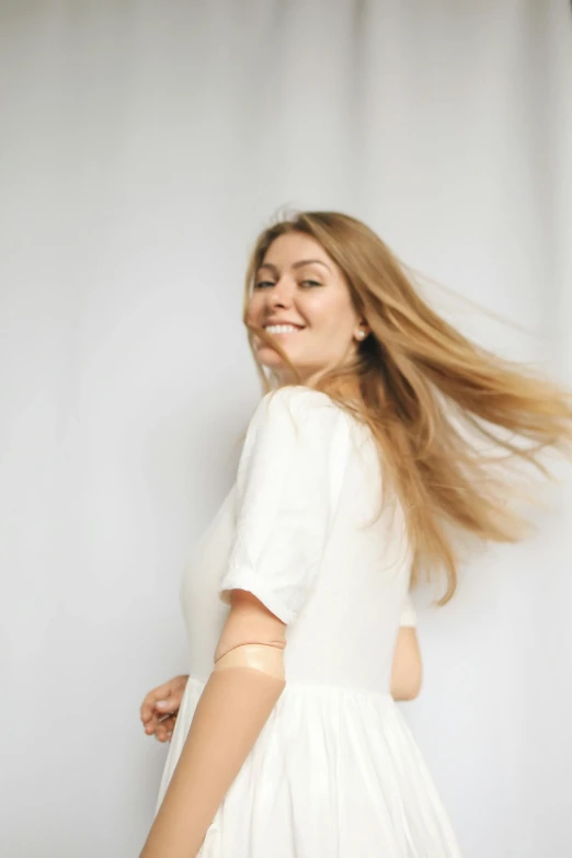 a woman in a white dress posing for a picture, pexels contest winner, happening, brown flowing hair, wearing a light shirt, excitement, kirsi salonen