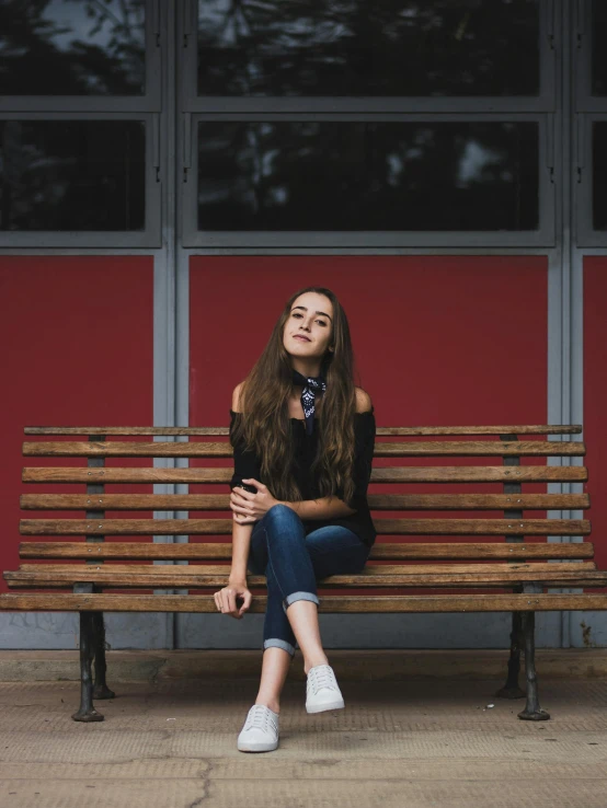 a woman sitting on top of a wooden bench, girl with dark brown hair, unsplash photography, teenage female schoolgirl, 15081959 21121991 01012000 4k