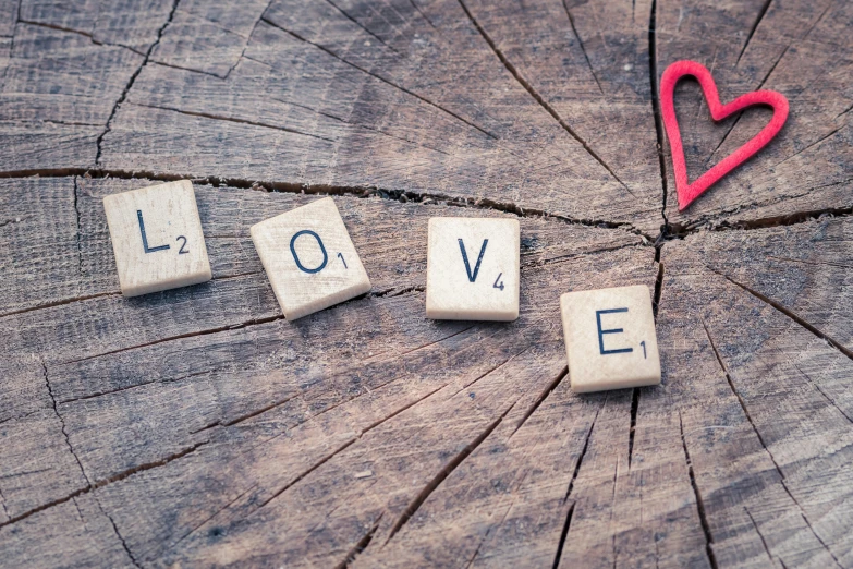 the word love spelled with scrabbles on a tree stump, pexels, 💋 💄 👠 👗, instagram post, panels, schools