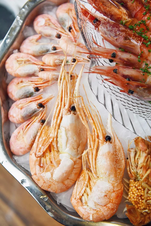 a close up of a tray of food on a table, crustacean, thumbnail, bo chen, golden