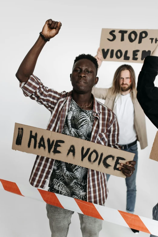 a group of men standing next to each other holding signs, an album cover, by Matija Jama, trending on pexels, black arts movement, that violence breeds violence, a blond, adut akech, subreddit / r / whale