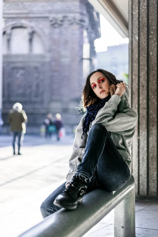 a woman sitting on top of a metal rail, a portrait, inspired by Anita Malfatti, pexels contest winner, with a bruised face and bruises, standing in a city center, promotional image, milan jozing