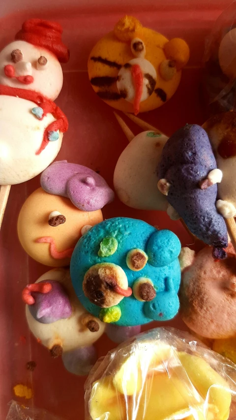 a pink plate topped with donuts covered in frosting, a cartoon, inspired by Damien Hirst, pexels, multicolored faces, dough sculpture, closeup - view, brains