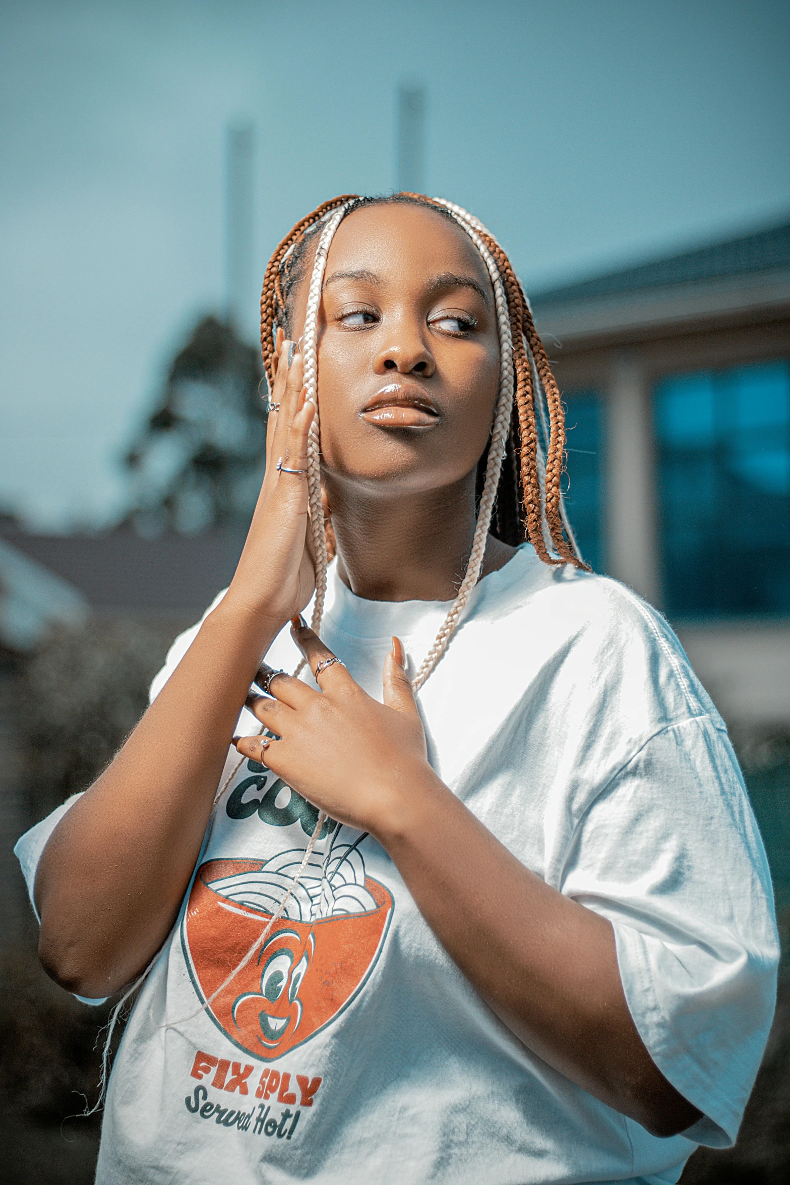 a woman with dreadlocks standing in front of a building, an album cover, trending on pexels, visual art, white braids, youthful taliyah, dressed in a white t shirt, portrait of gigachad