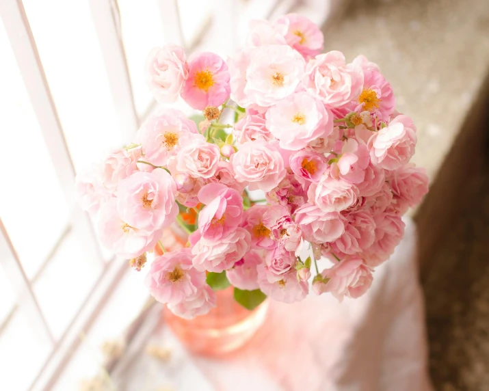 a vase filled with pink flowers sitting on a window sill, pastel roses, precious moments, full product shot, cheery