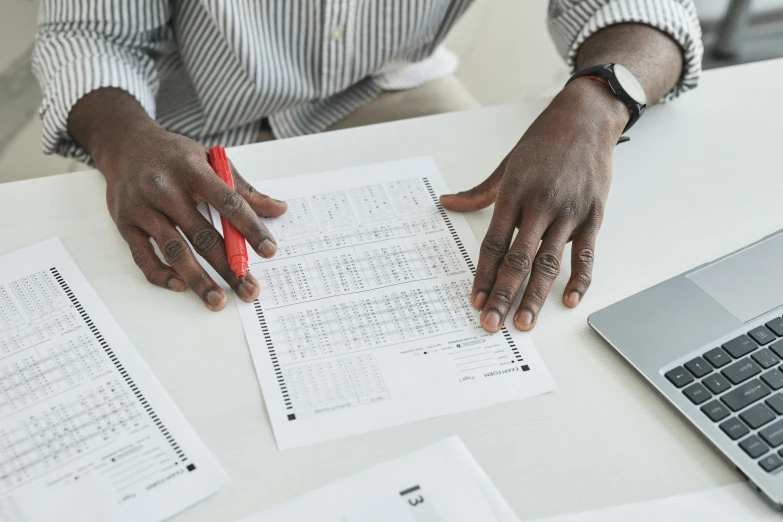 a person sitting at a table with papers and a laptop, square lines, uploaded, maintenance, commercial