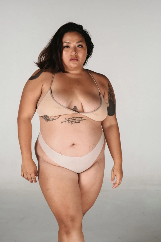 a woman in a bikini posing for a picture, by Matija Jama, reddit, morbidly obese, half asian, set against a white background, her skin is light brown