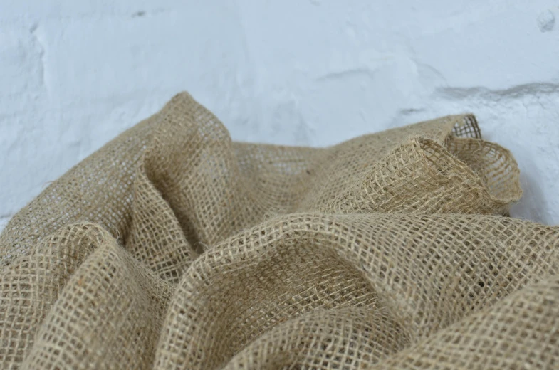 a close up of a piece of burlock fabric, hessian cloth, heavy grain-s 150, frill, rustic