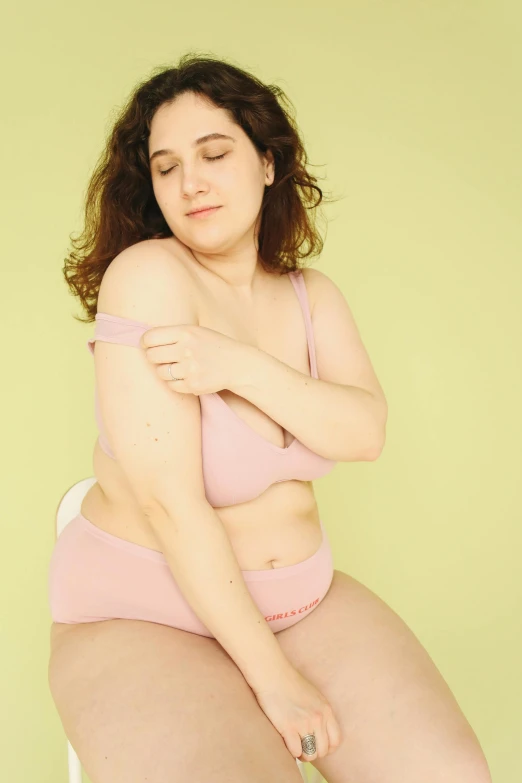 a woman in a pink bikini sitting on a stool, inspired by Ren Hang, trending on pexels, renaissance, overweight, depressed dramatic bicep pose, someone sits in bed, rebecca sugar