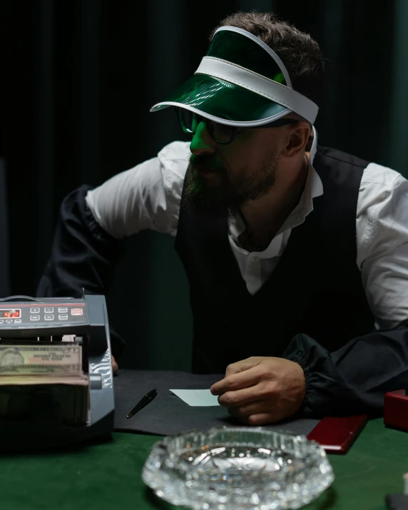 a man wearing a visor sitting at a table, a hologram, pexels contest winner, hyperrealism, the card player man, green suit and bowtie, [ theatrical ]