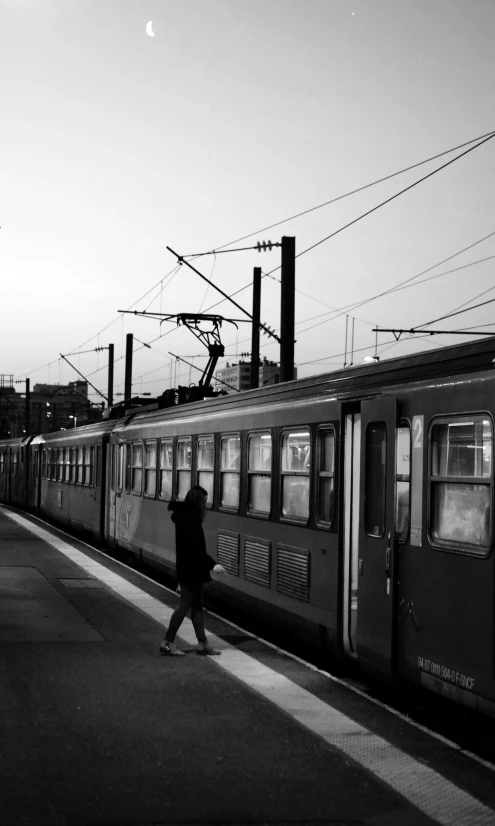 a black and white photo of a train at a train station, by Mathias Kollros, silhouetted, paris 2010, connecting lines, 🚿🗝📝