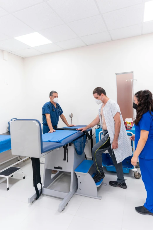 a group of people standing around a hospital bed, in spain, profile image, thumbnail, maintenance