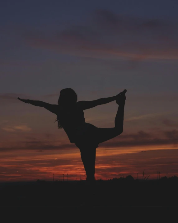 a woman doing a yoga pose at sunset, pexels contest winner, dynamic pose full body, grainy, holding a 🛡 and an 🪓, low quality photo