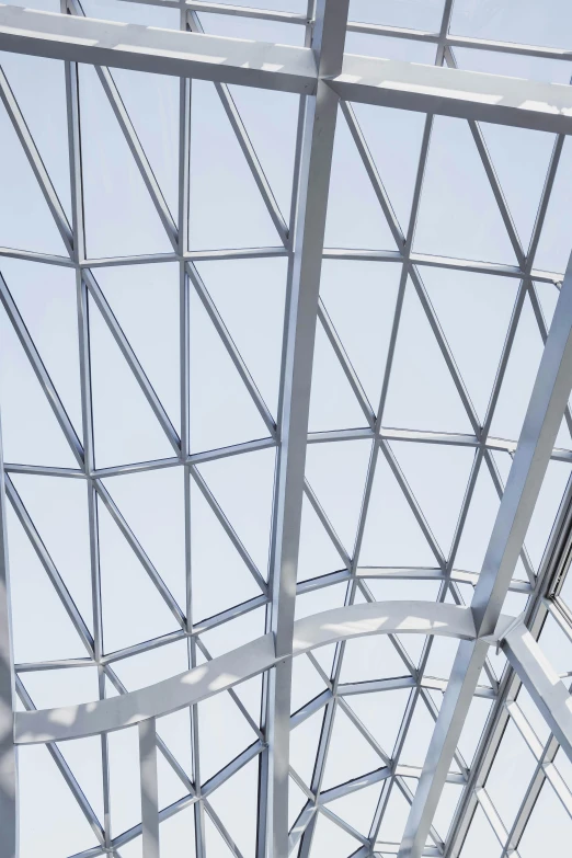 a man riding a skateboard on top of a metal structure, inspired by Richard Wilson, trending on unsplash, conceptual art, geodesic dome, square facial structure, atrium, closeup - view