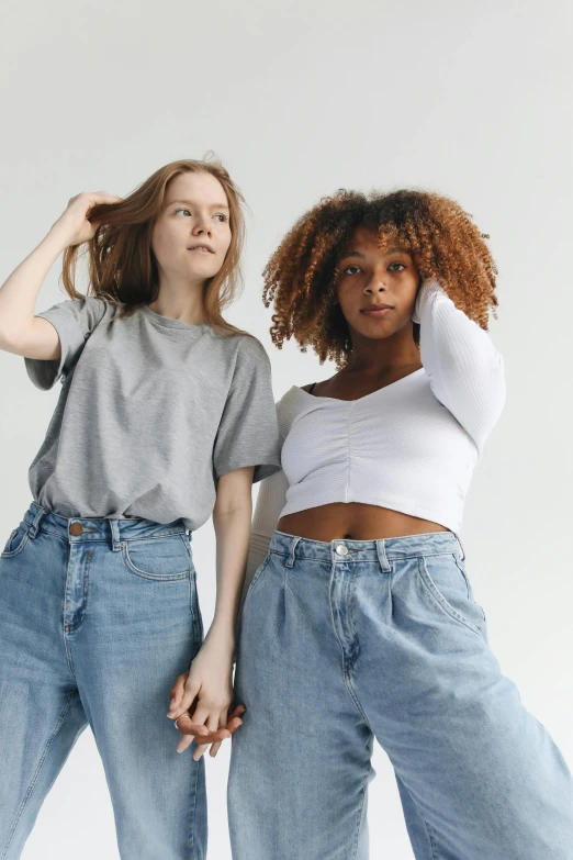 a couple of women standing next to each other, trending on pexels, renaissance, wearing pants and a t-shirt, wavy hair spread out, diverse ages, very pale