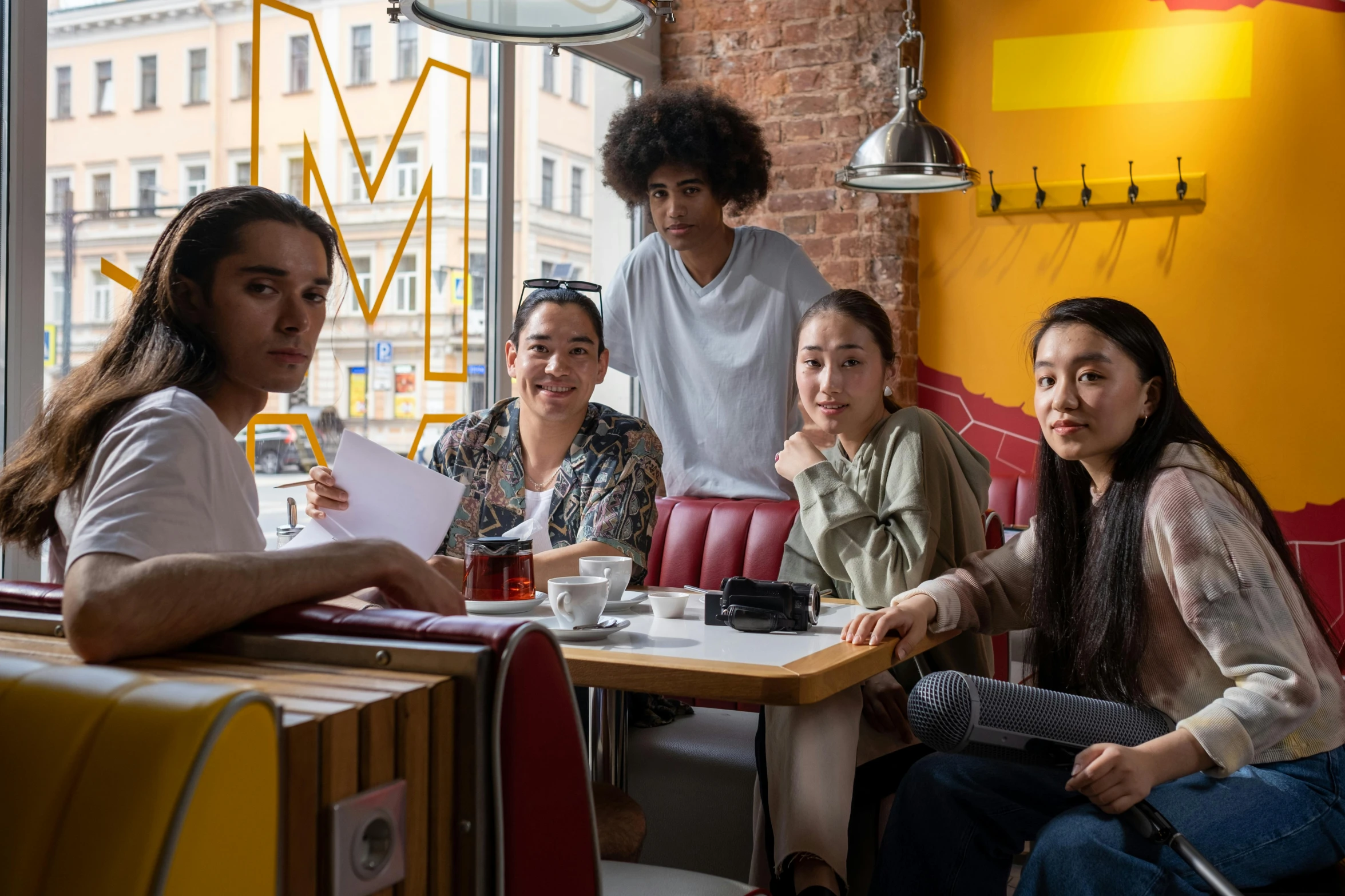 a group of people sitting at a table in a restaurant, a portrait, by Alice Mason, pexels contest winner, altermodern, asian female, cast, aida muluneh, promotional image