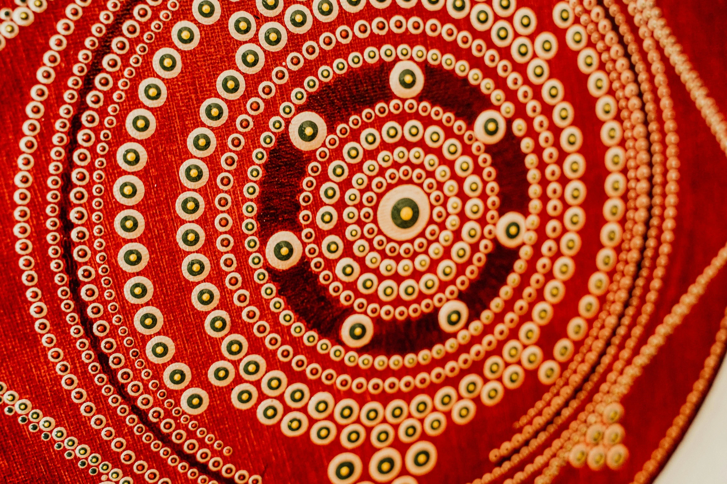 a red rug with a spiral design on it, a detailed painting, inspired by Kusama, pexels, close up shot of an amulet, australia intricate, red white and gold color scheme, indigenous art