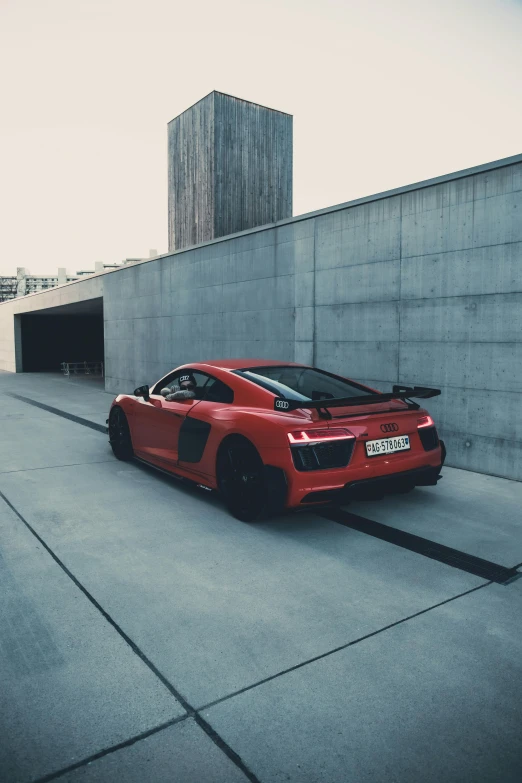 a red sports car parked in front of a concrete wall, a picture, by Adam Marczyński, pexels contest winner, square, full body shot 4k, 15081959 21121991 01012000 4k, back facing the camera