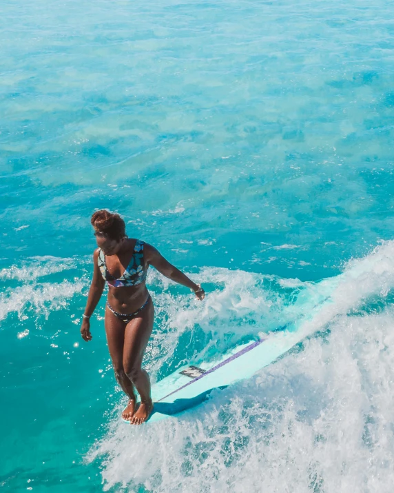 a woman riding a wave on top of a surfboard, slightly tanned, thumbnail, teal aesthetic, tourist photo