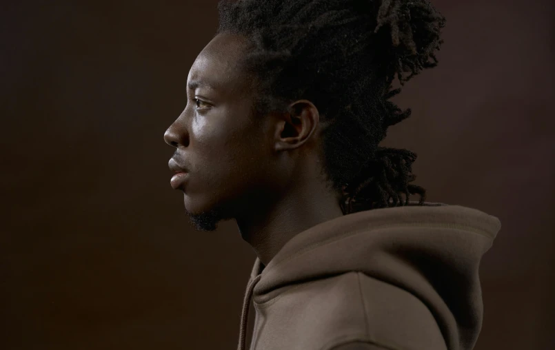 a close up of a person wearing a hoodie, an album cover, inspired by Charles Martin, trending on pexels, hyperrealism, ( brown skin ), elegant profile posing, pouty look :: octane render, chiaroscuro portrait