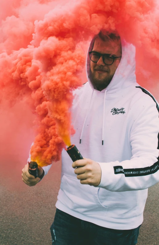 a man in a white hoodie holding a red smoke bomb, :6 smoke grenades, in colour, outlive streetwear collection, covered in ketchup